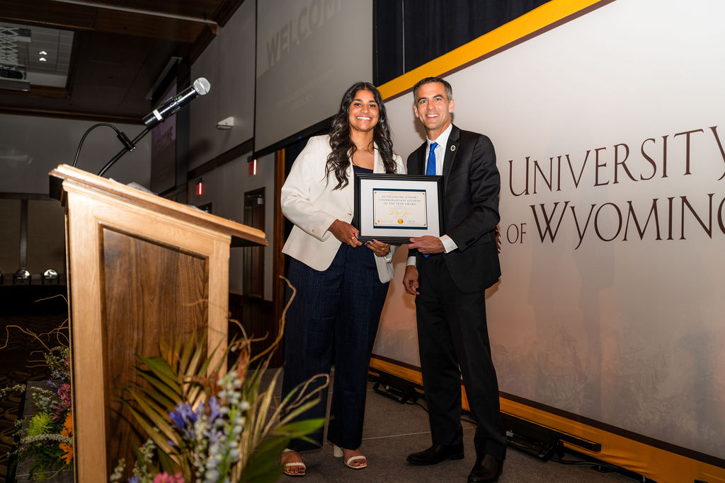 Scott Beaulier presenting an award at the University of Wyoming